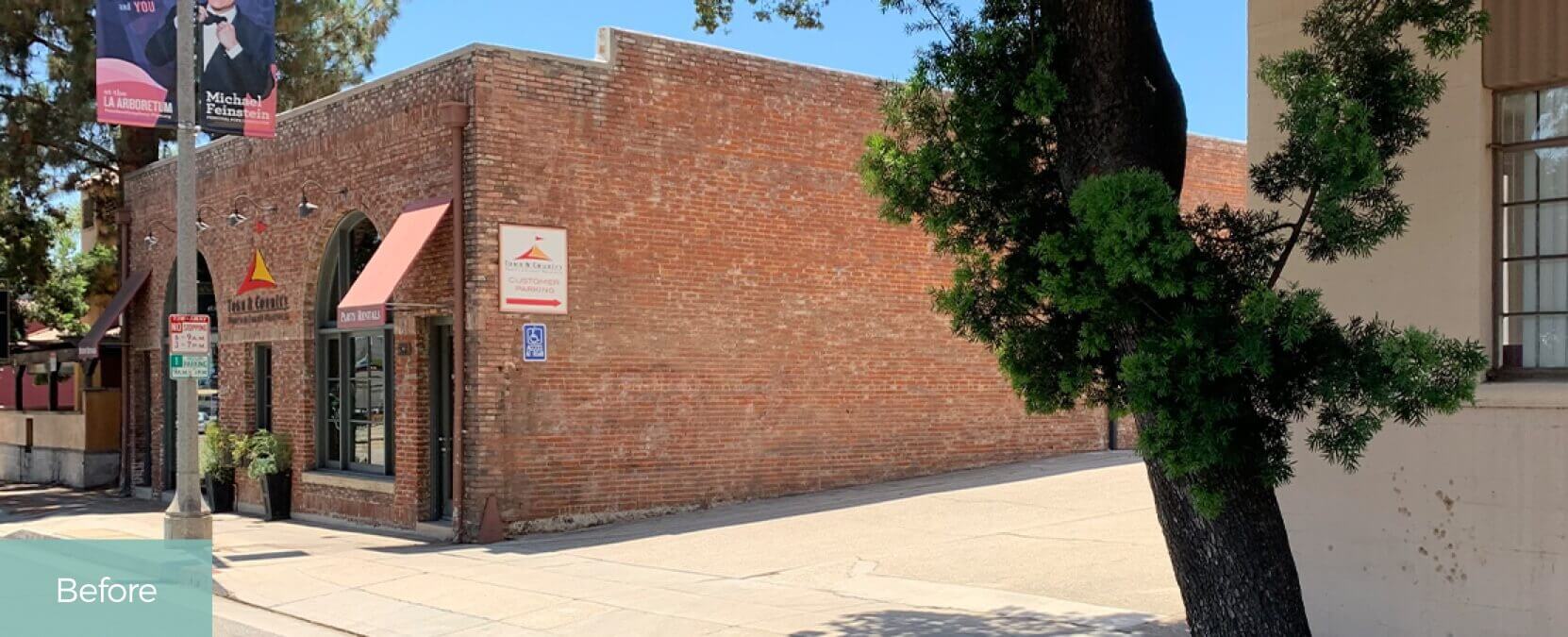 Existing one-story brick building, street light pole, traffic signage