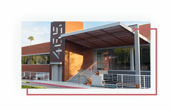 Street-level view of Pasadena building, stairs, awning, glass entrance